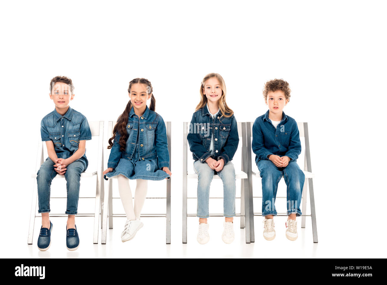 four kids in denim clothes sitting on 