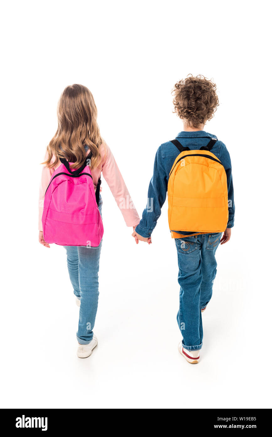 back view of schoolchildren with backpacks holding hands isolated on ...