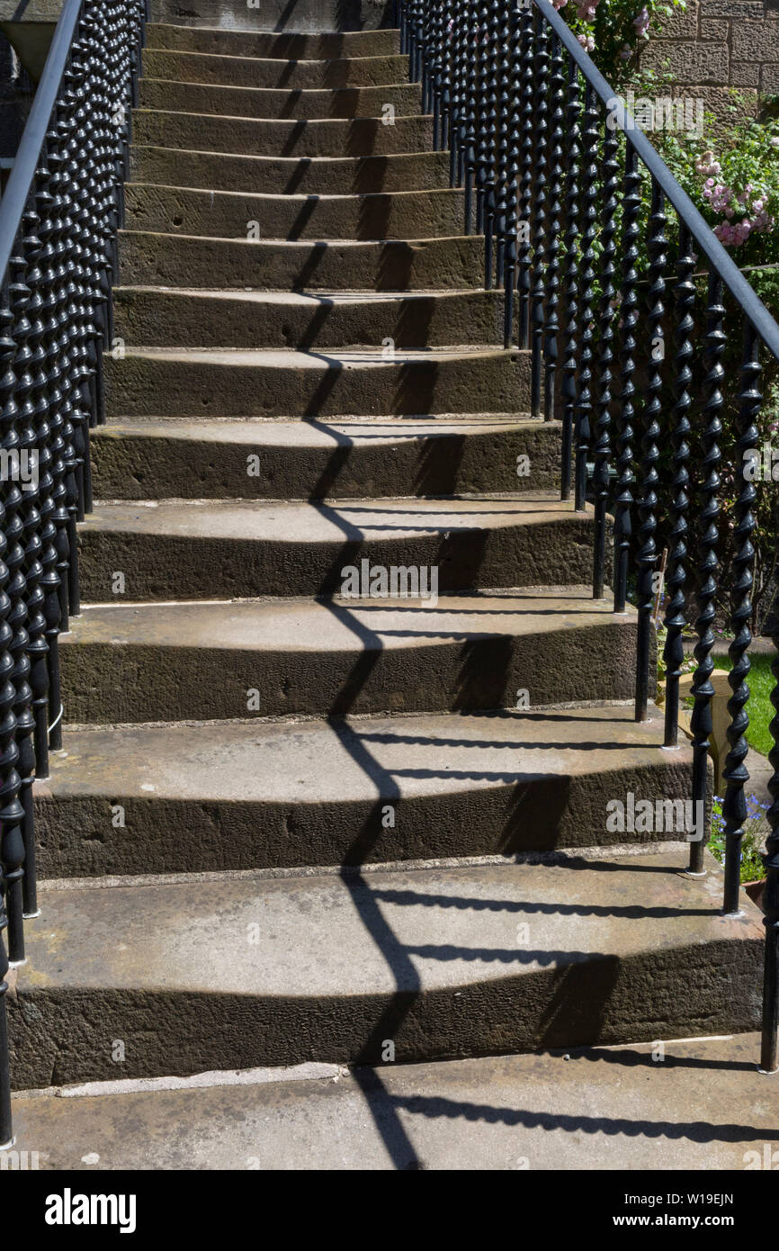 Worn Victorian steps and terraced housing on Teviotdale Place alongside the Waters of Leith, in Edinburgh, on 26th June 2019, in Edinburgh, Scotland. Stock Photo