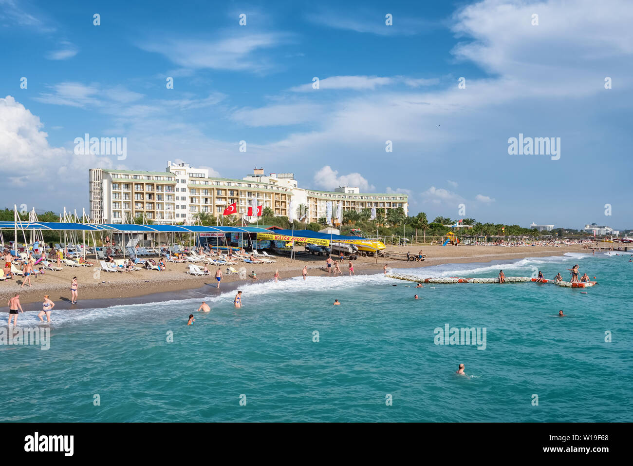 Sandy beach near the holiday complex hotel at the Mediterranean sea near Antalya, Turkey Stock Photo