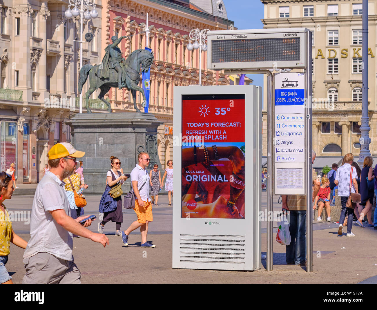 Zagreb, Croatia, July 1,2019.  Electronic billboard with Coca Cola ad showing the temperature as 35 degrees Celsius in main city square Stock Photo