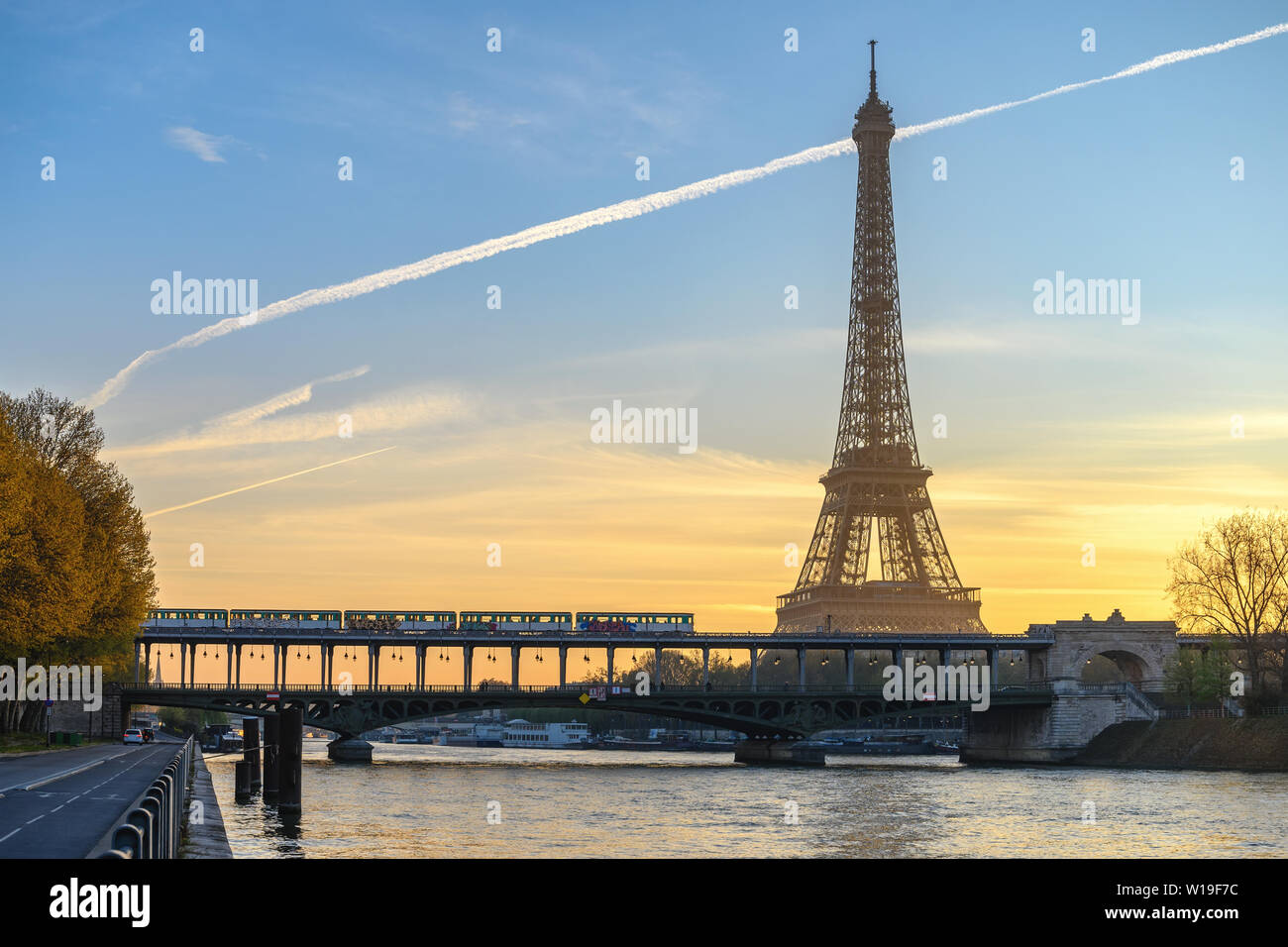 Paris France city skyline sunrise at Eiffel Tower and Seine River with Pont de Bir-Hakeim bridge and Paris Metro Stock Photo