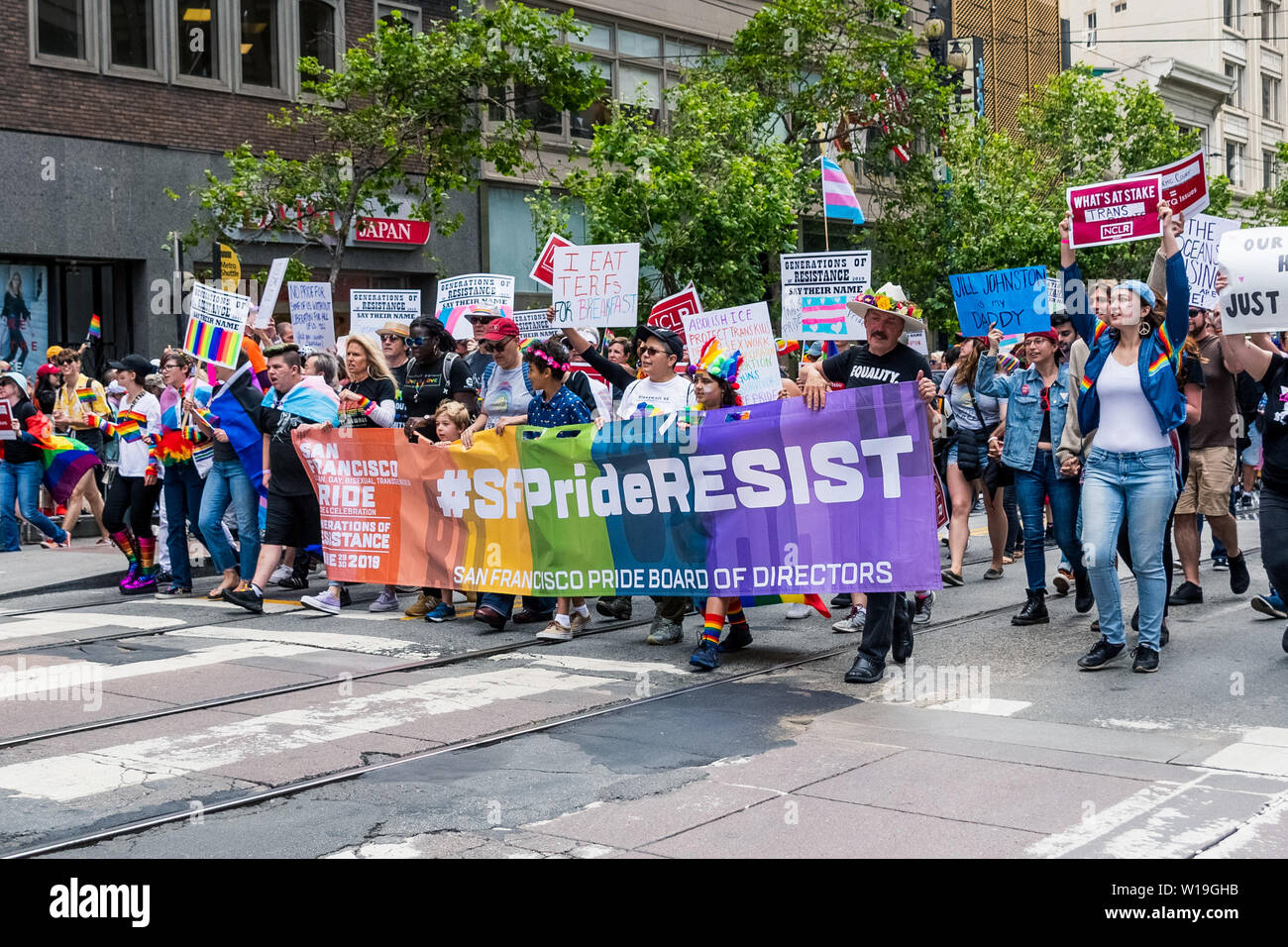 June 30, 2019 San Francisco / CA / USA - Participants at the 2019 San Francisco Pride Parade carrying a #SFPrideResist sign Stock Photo