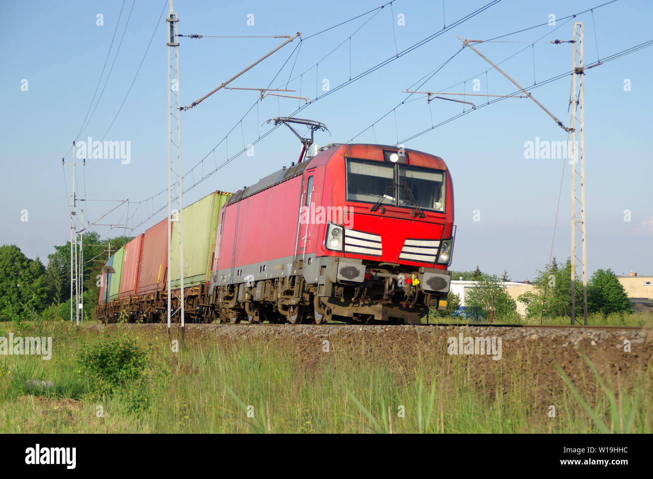 Fast electric train on tracks. Freight railway transport in Europe. Stock Photo