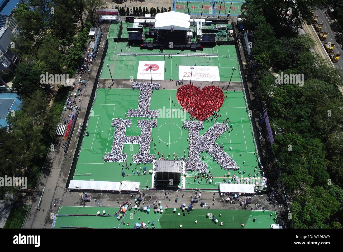 Hong Kong. 1st July, 2019. Aerial photo taken on July 1, 2019 shows a formation which spells out the words 'I LOVE HK' to celebrate the 22nd birthday of the Hong Kong Special Administrative Region (HKSAR) in south China's Hong Kong. About 5,000 people gathered at Victoria Park in Hong Kong on Monday and stood in the formation spelling out words 'I LOVE HK' to celebrate the 22nd birthday of the Hong Kong Special Administrative Region (HKSAR). Credit: Lui Siu Wai/Xinhua/Alamy Live News Stock Photo