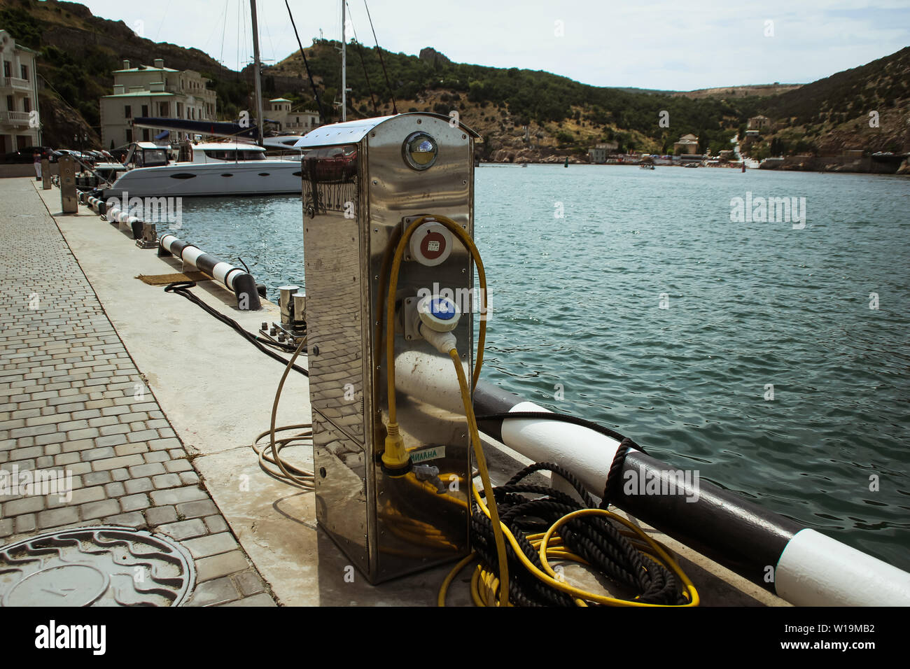 Balaklava, Russia - june 26, 2019: Electricity and water station in yacht harbor. Charging station for boats, electrical outlets in harbor. Electrical Stock Photo