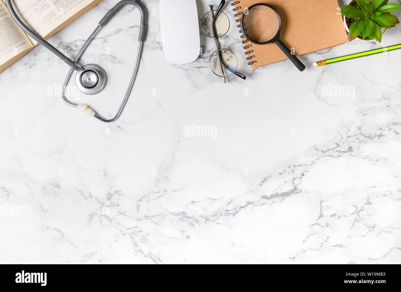 Top view of doctor desk marble table with stethoscope and notebook ...