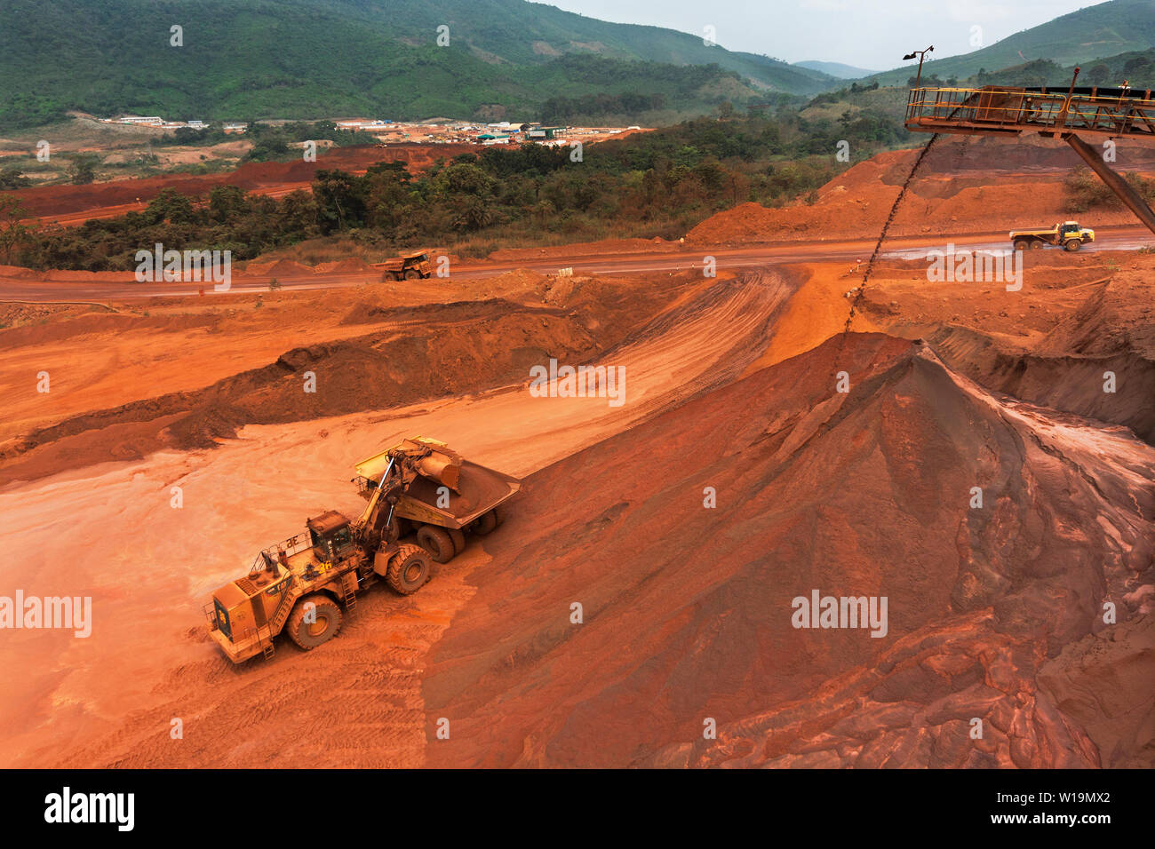 Mining operations for transporting and managing iron ore. From top of lump stacker showing loading fines from fines stacker before train transport. Stock Photo