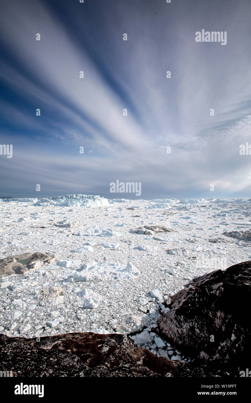 Melting ice from the world's fastest moving glacier, the Jakobshavn Glacier near Ilulissat on Greenland. Global warming have accellerated the melting and calving of the ice bergs. Stock Photo