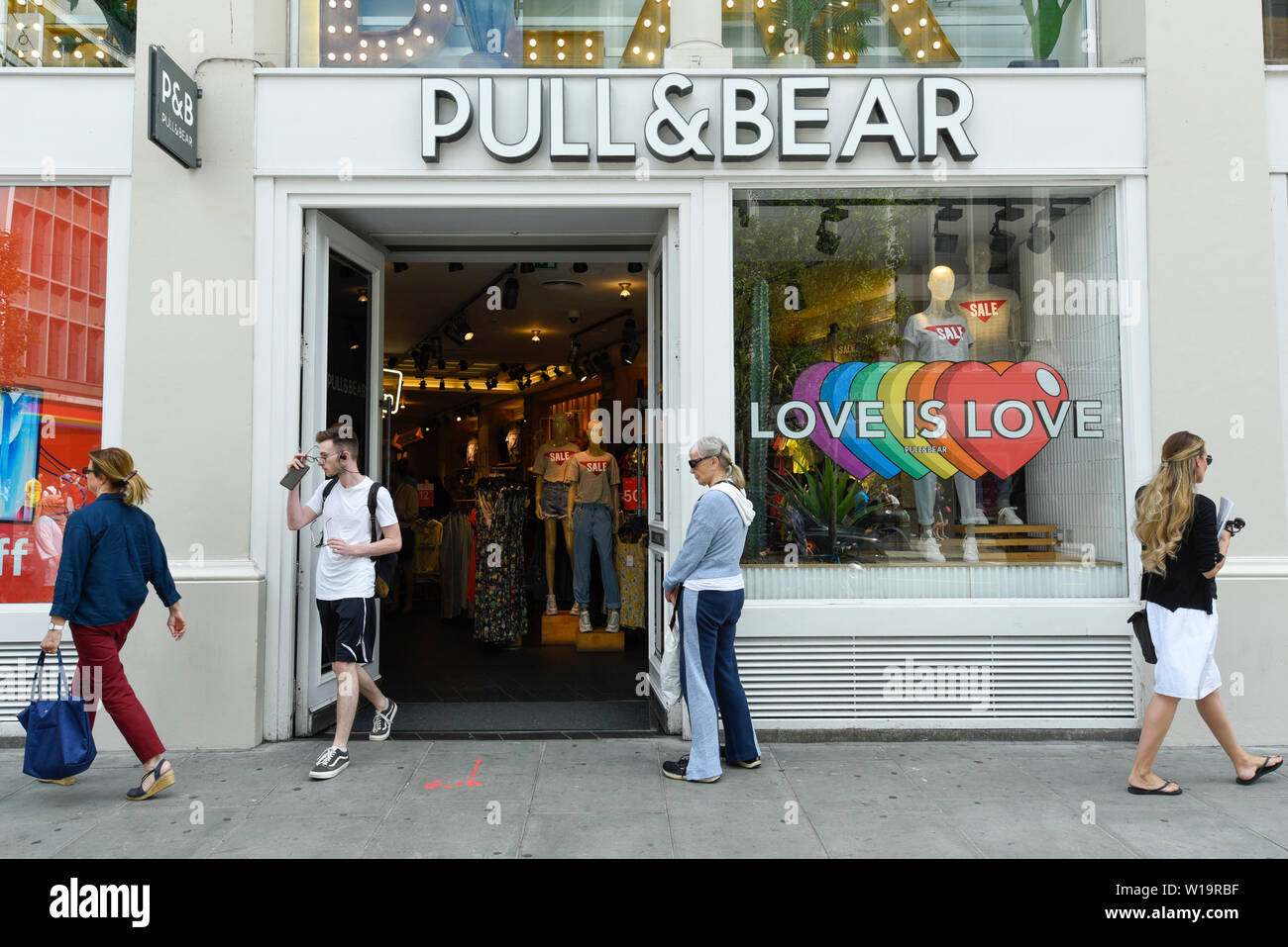 London, UK. 1 July 2019. The Pull & Bear store in Oxford Street is one of  many stores in the capital's West End whose exteriors are decorated in  rainbow colours in support