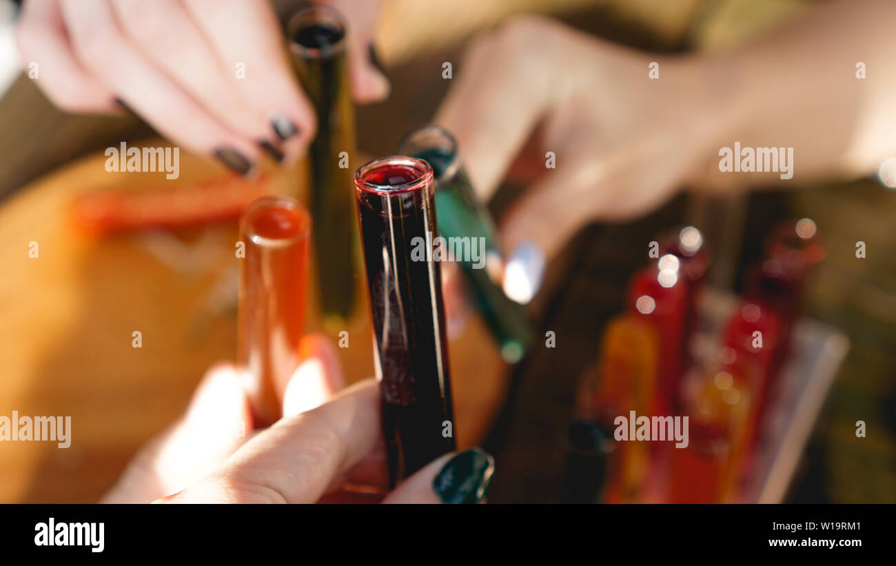 Test tubes with multicolored liquid. Alcohol in test tubes dark bar