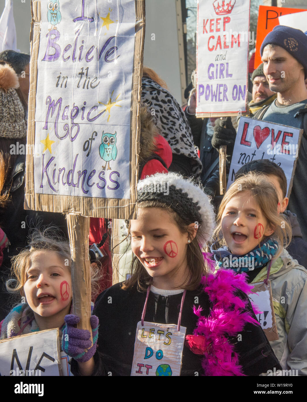 Women's March, London, UK, 21st January 2017. A young girl holds a placard with the message 'I believe in the magic of kindness' as women, men and children take to the streets in London to protest the day after the inauguration of President Donald Trump. Up to 10,000 took part in the London women's march as people worldwide marked the day by marching in an act of international solidarity. Stock Photo