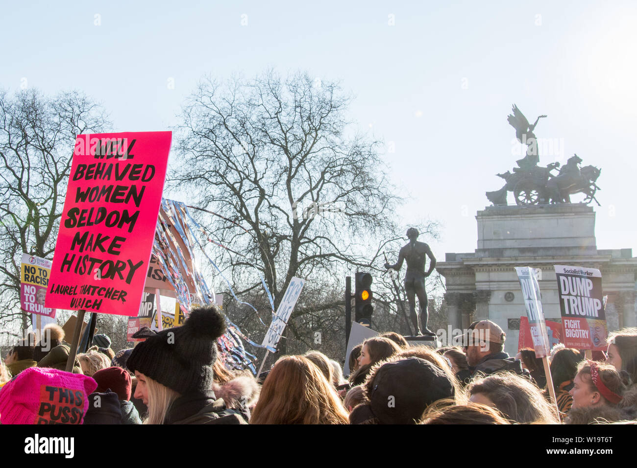 London, UK, 21st January 2017. A placard with the Laurel Thatcher Ulrich quote 'Well behaved women seldom make history' is seen in the crowd as people take to the streets for the Women's march in London. The protest took place the day after the inauguration of President Donald Trump. Up to 10,000 took part in London as women worldwide marked the day by marching in an act of international solidarity. The Wellington Arch can be seen in the background, topped with the statue 'Peace Descending on the Chariot of War' Stock Photo