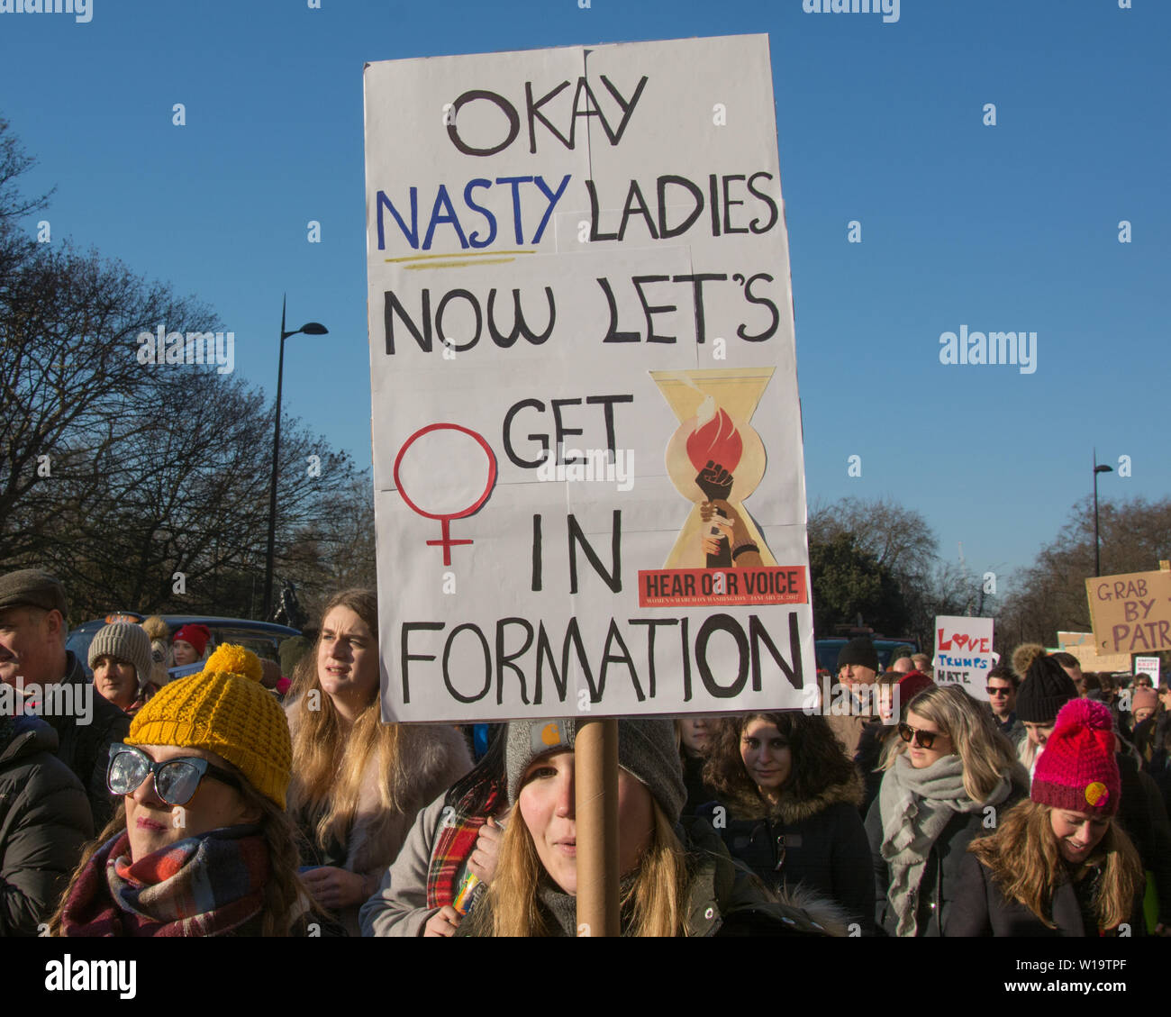 Women's March, London, UK, 21st January 2017. A female protester carries a placard paraphrasing a line in the Beyonce song 'Formation' during a protest the day after the inauguration of President Donald Trump. In full it reads 'Okay nasty ladies now let's get in formation'. Up to 10,000 took part in London as women worldwide marked the day by marching in an act of international solidarity. Stock Photo