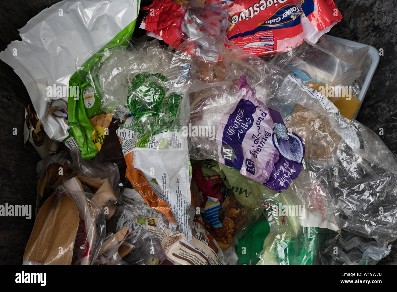 Rubbish, mailny non recyclable plastic food packaging, in household bin. UK Stock Photo