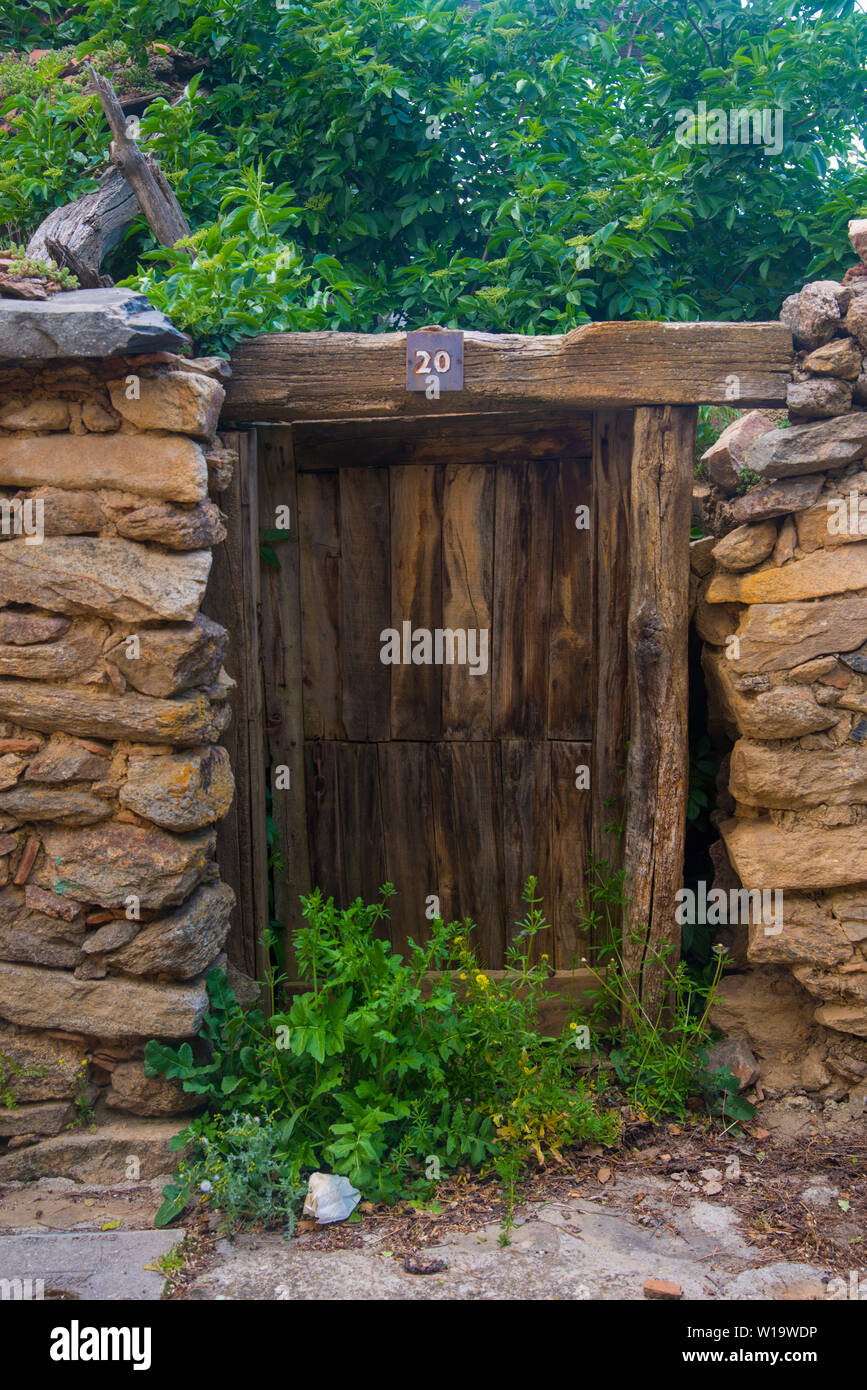 Old door of house in ruins. Braojos, Madrid province, Spain. Stock Photo