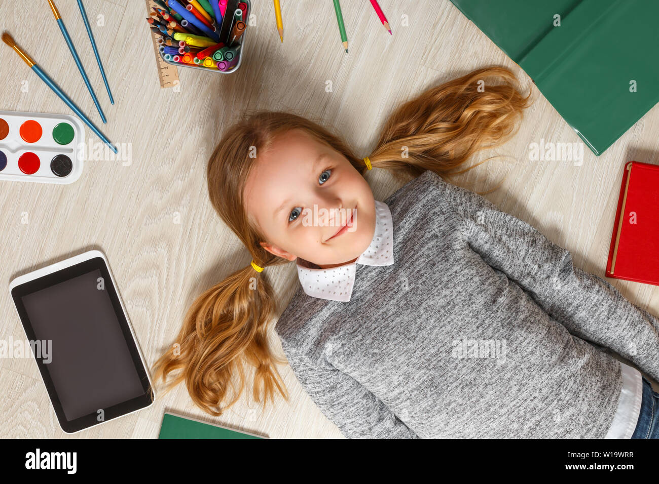 Little girl lying on the floor on her back hires stock photography and images Alamy