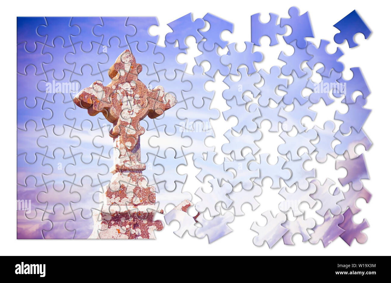 Patiently building of faith - Celtic carved stone cross against a sky background - concept image in jigsaw puzzle shape Stock Photo