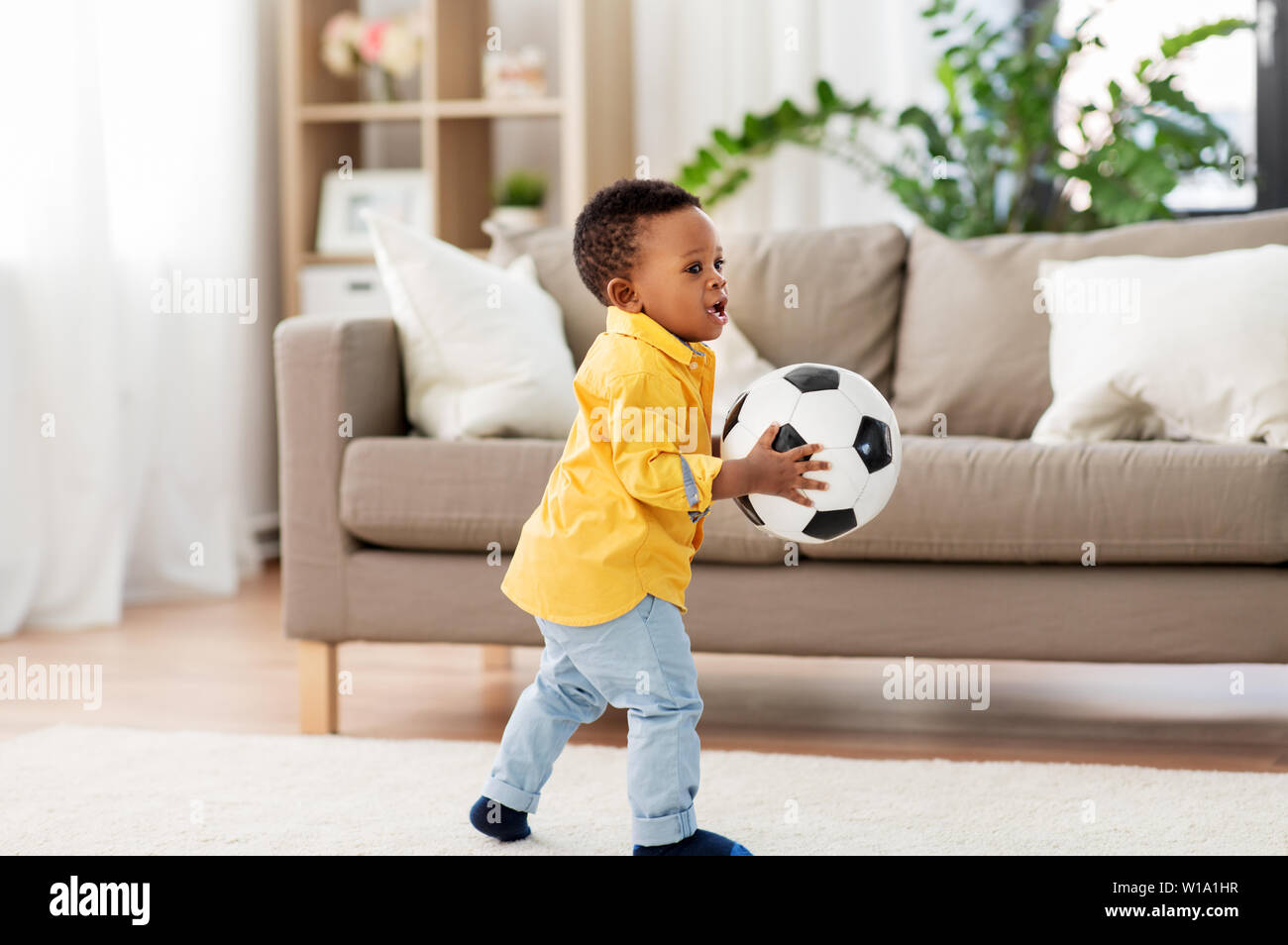 african american baby boy playing with soccer ball Stock Photo - Alamy