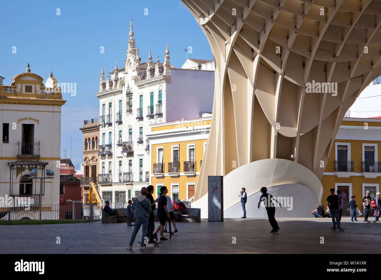 Skateboarders beneath the Metropol Parasol in the Plaza de la Encarnacion in Seville, Spain. Stock Photo
