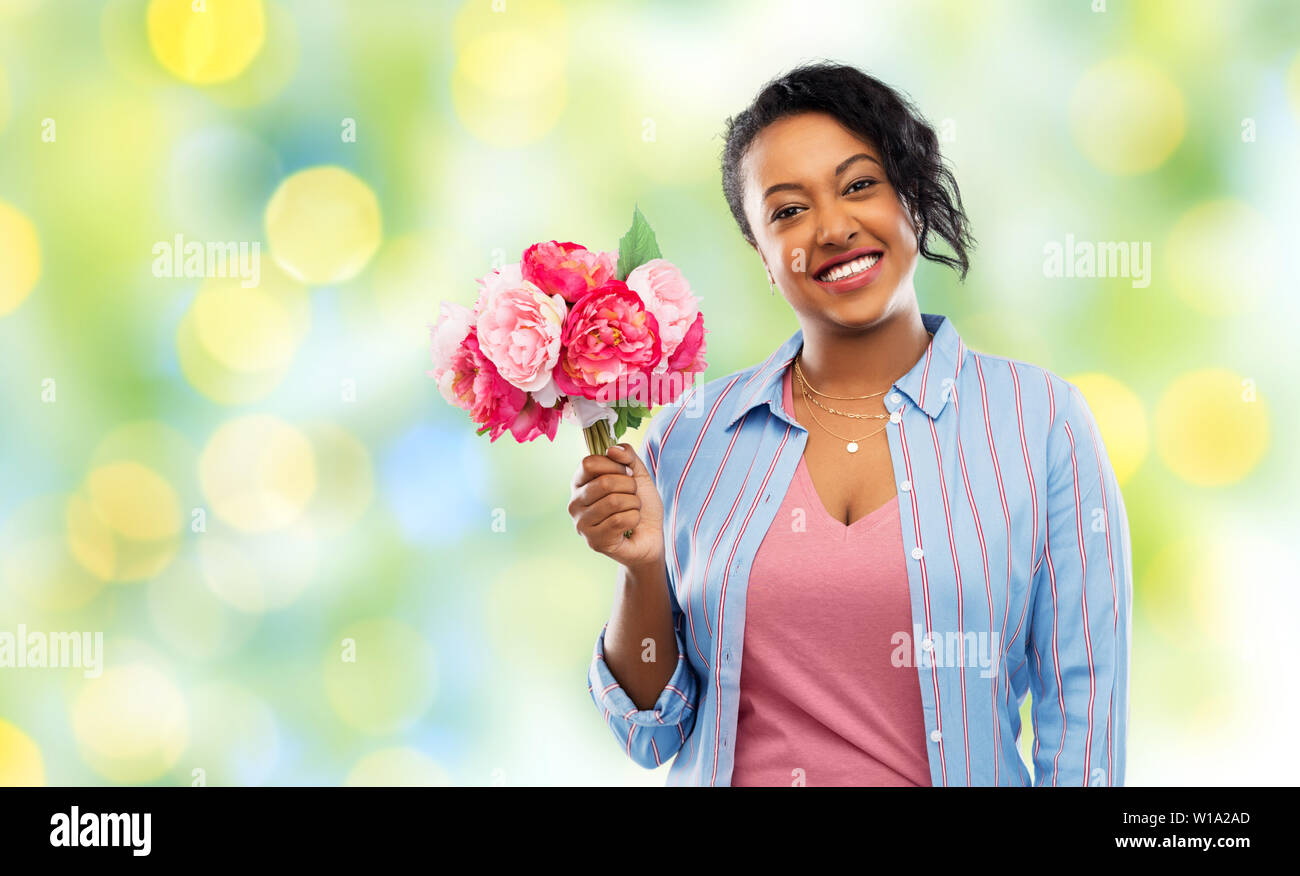 happy african american woman with bunch of flowers Stock Photo - Alamy
