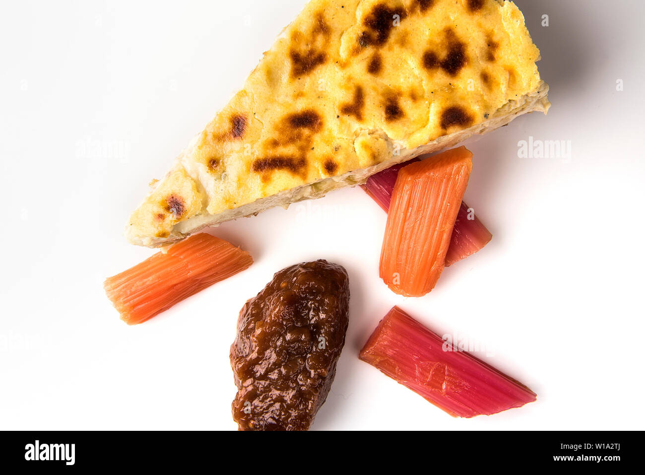 savoury baked cheesecake with pickled rhubarb and rhubarb chutney Stock Photo