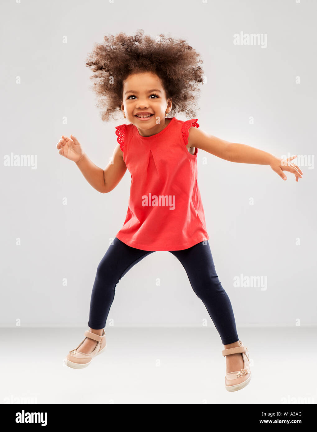 Little Africanamerican Girl Jumping Over Studio Background Stock Photo -  Download Image Now - iStock