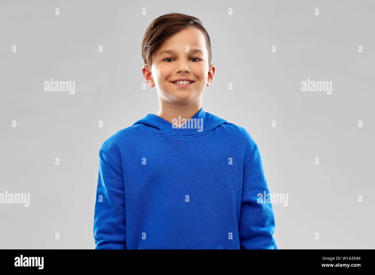 portrait of smiling boy in blue hoodie Stock Photo Alamy