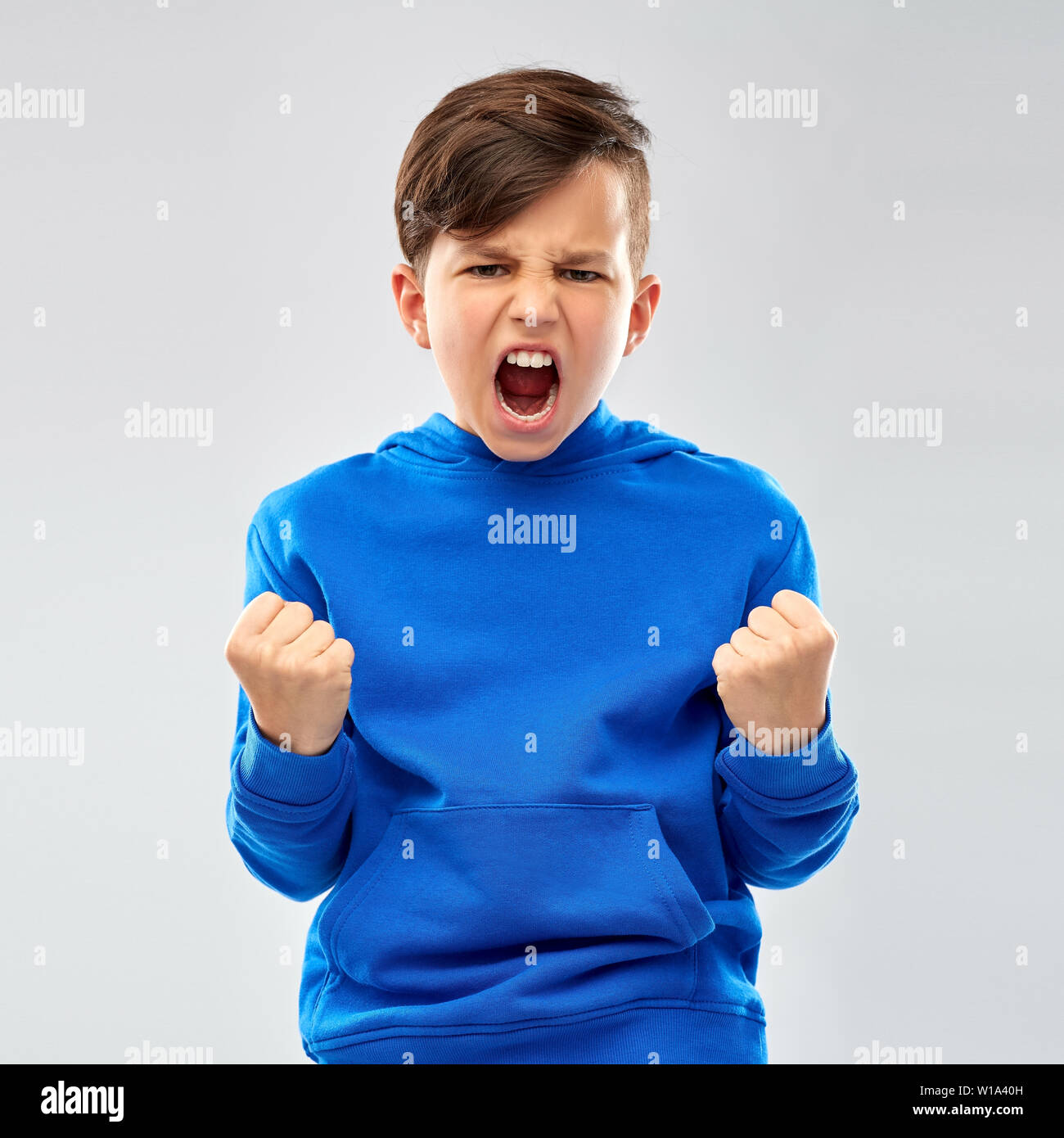 angry boy in blue hoodie celebrating success Stock Photo Alamy
