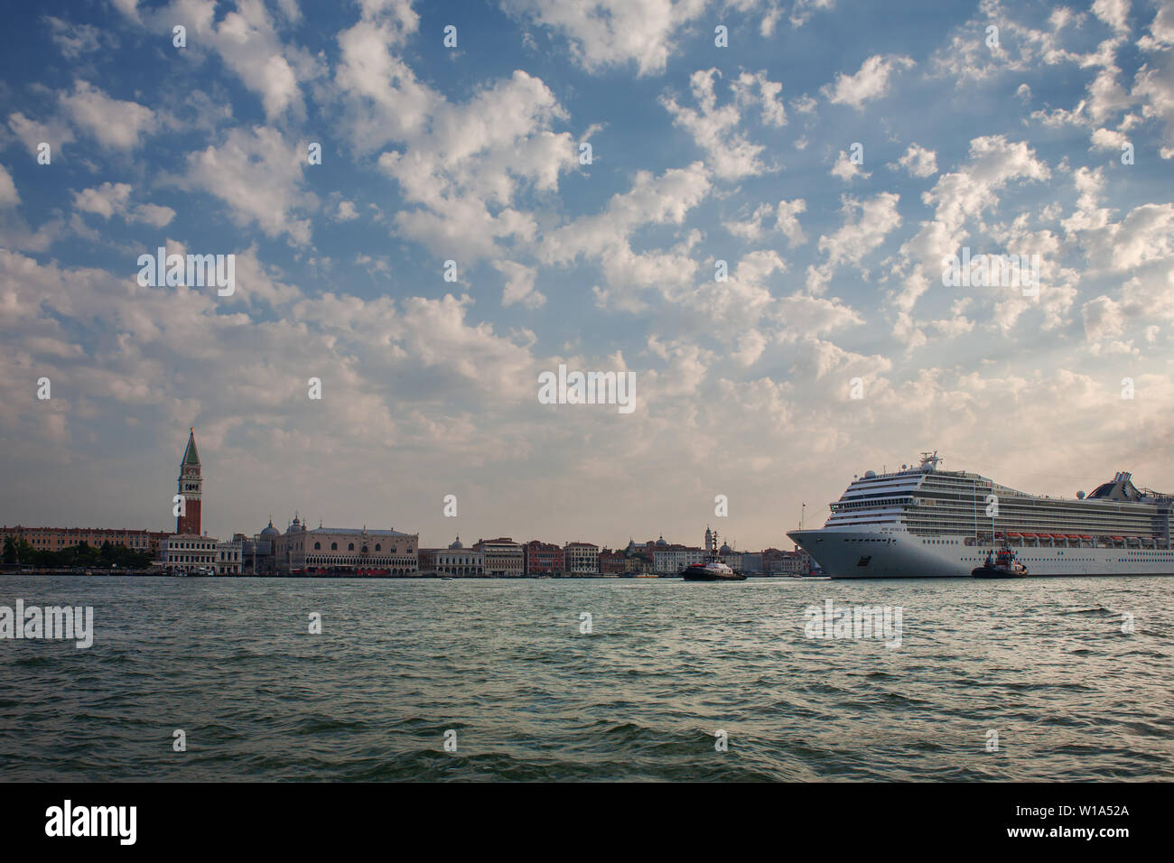 A huge cruise liner in the Canale di San Marco dwarfs the San Marco waterfront, Venice, Italy Stock Photo