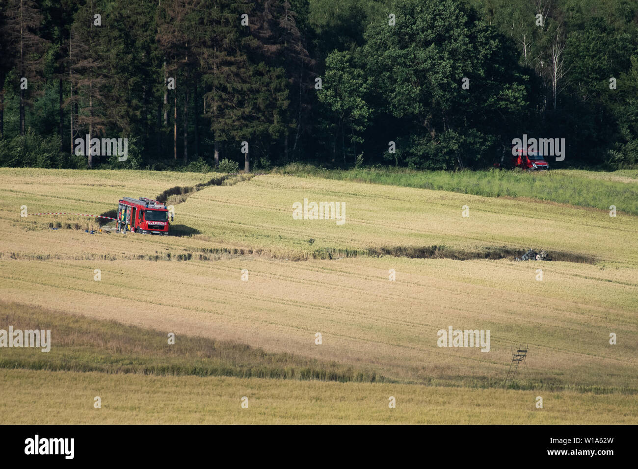 Aerzen, Germany. 01st July, 2019. A fire engine of the fire brigade stands next to the crash site of a Bundeswehr helicopter. The Bundeswehr has confirmed the crash of a training helicopter in Lower Saxony. The Eurocopter EC 135 machine crashed around 2 p.m. near Dehmkerbrock, about 30 kilometres west of Hameln, said a Bundeswehr spokesman to the German Press Agency on Monday. There had been two people on board. The aircraft belongs to the International Helicopter Training Centre in Bückeburg. Credit: Swen Pförtner/dpa/Alamy Live News Stock Photo