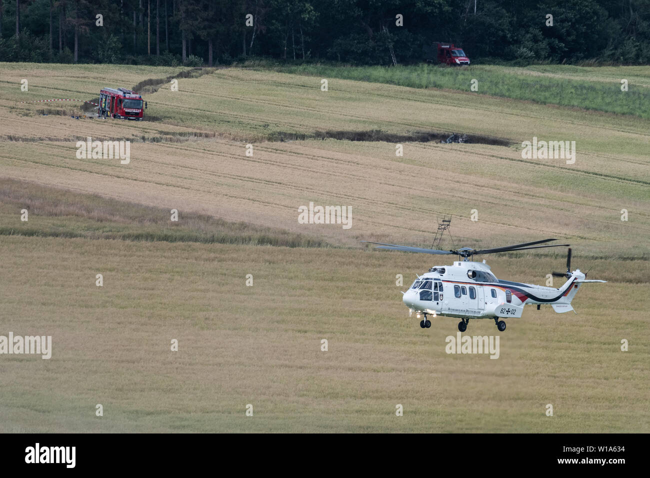 Aerzen, Germany. 01st July, 2019. The helicopter with Federal Defence Minister Ursula von der Leyen (CDU) on board circles at the crash site of a Bundeswehr helicopter. The Bundeswehr has confirmed the crash of a training helicopter in Lower Saxony. The Eurocopter EC 135 machine crashed around 2 p.m. near Dehmkerbrock, about 30 kilometres west of Hameln, said a Bundeswehr spokesman to the German Press Agency on Monday. There had been two people on board. The aircraft belongs to the International Helicopter Training Centre in Bückeburg. Credit: Swen Pförtner/dpa/Alamy Live News Stock Photo