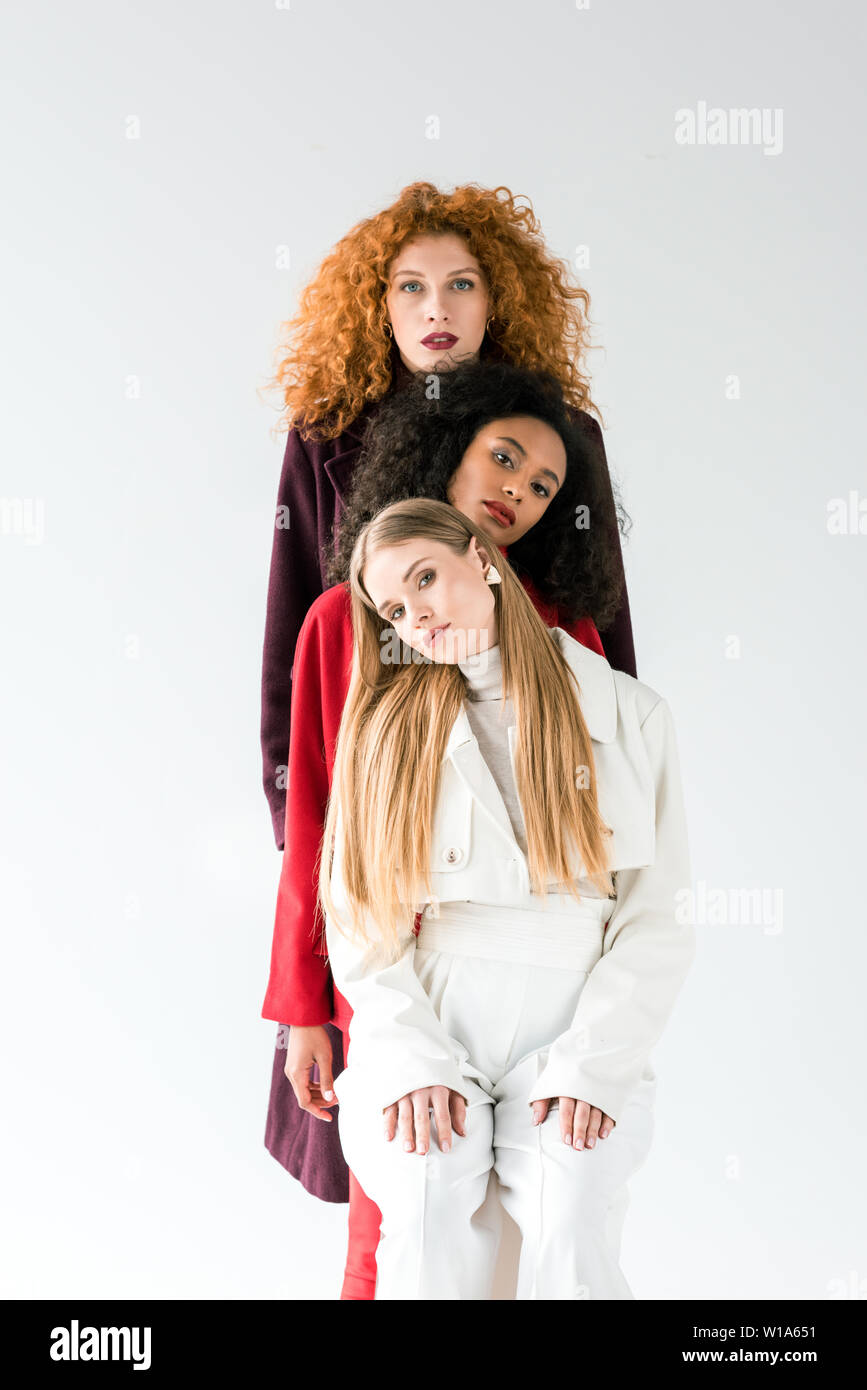 Blonde And Redhead Women Standing With African American Girl On