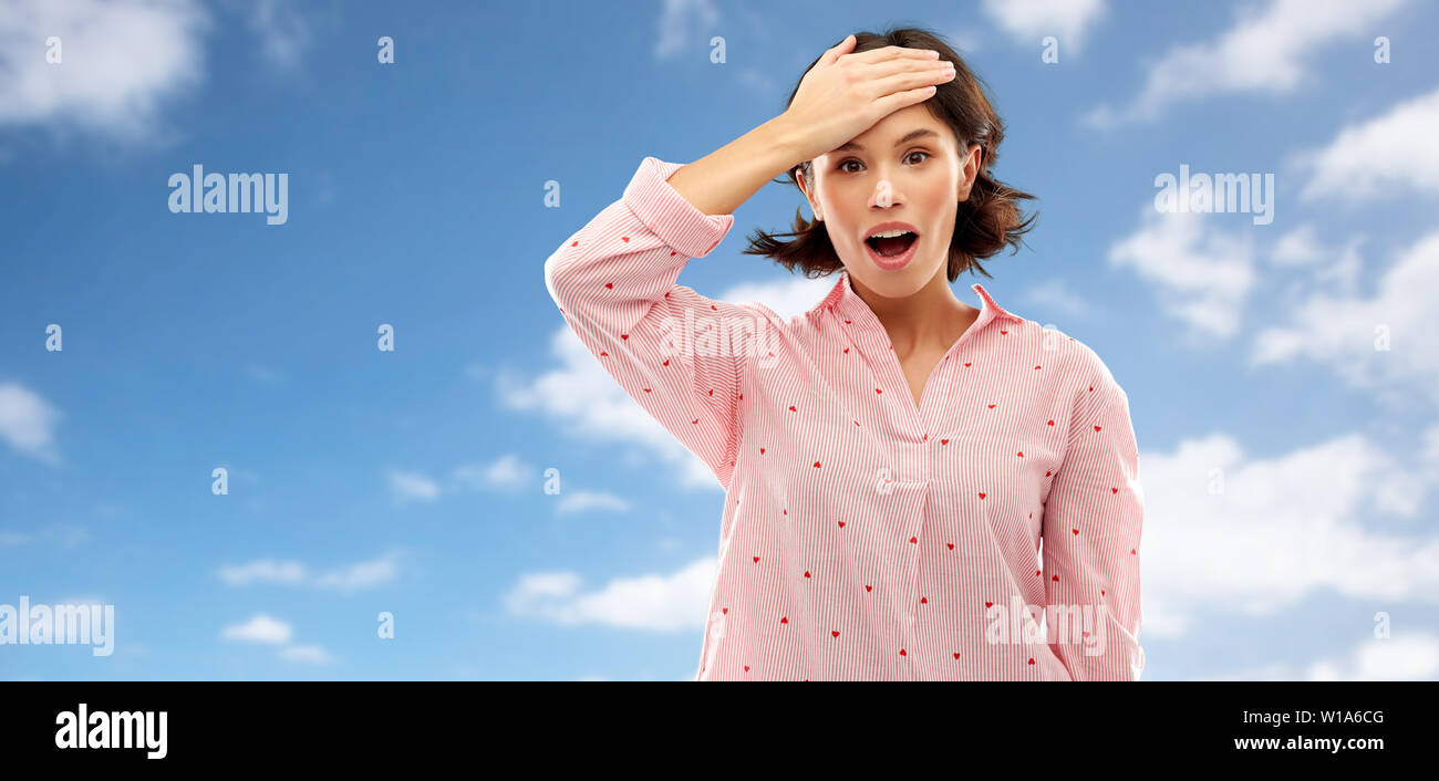 confused young woman in pajama over sky Stock Photo