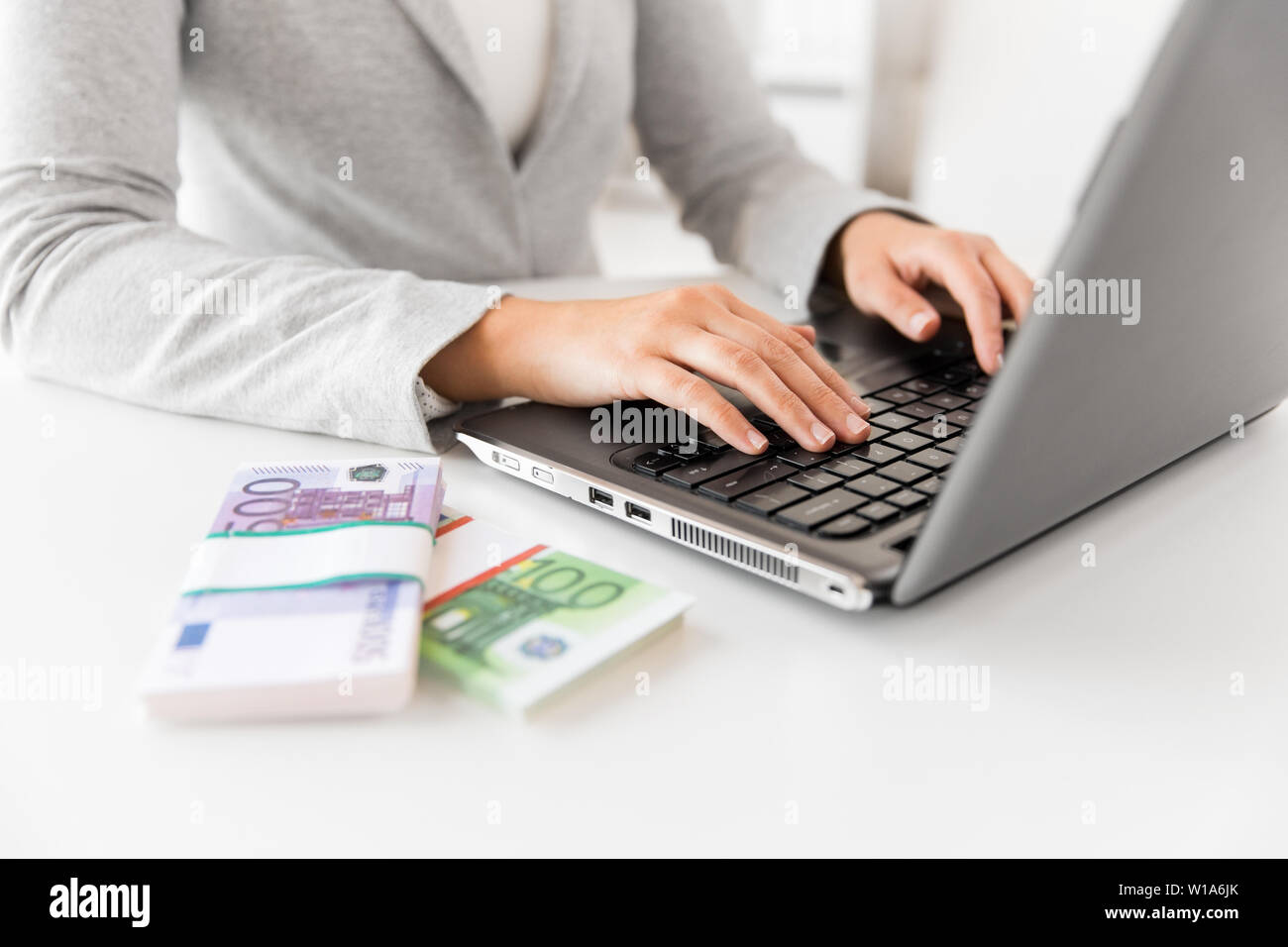 close up of businesswoman with laptop and money Stock Photo