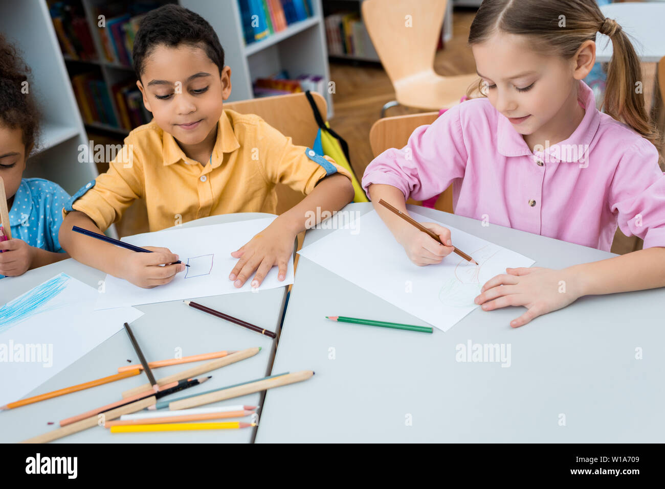 cute multicultural children drawing on papers with color pencils Stock ...