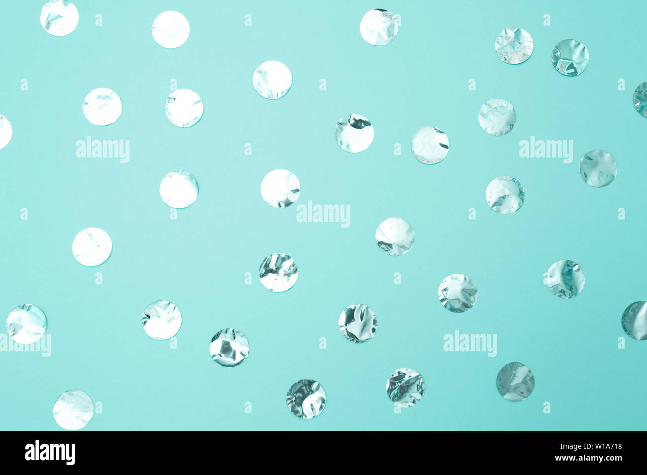 Pattern of shiny silver confetti on pastel turquoise paper background.  Concept of holiday, birthday, blogging, beauty. Top view. Flat lay. Minimal  sty Stock Photo - Alamy