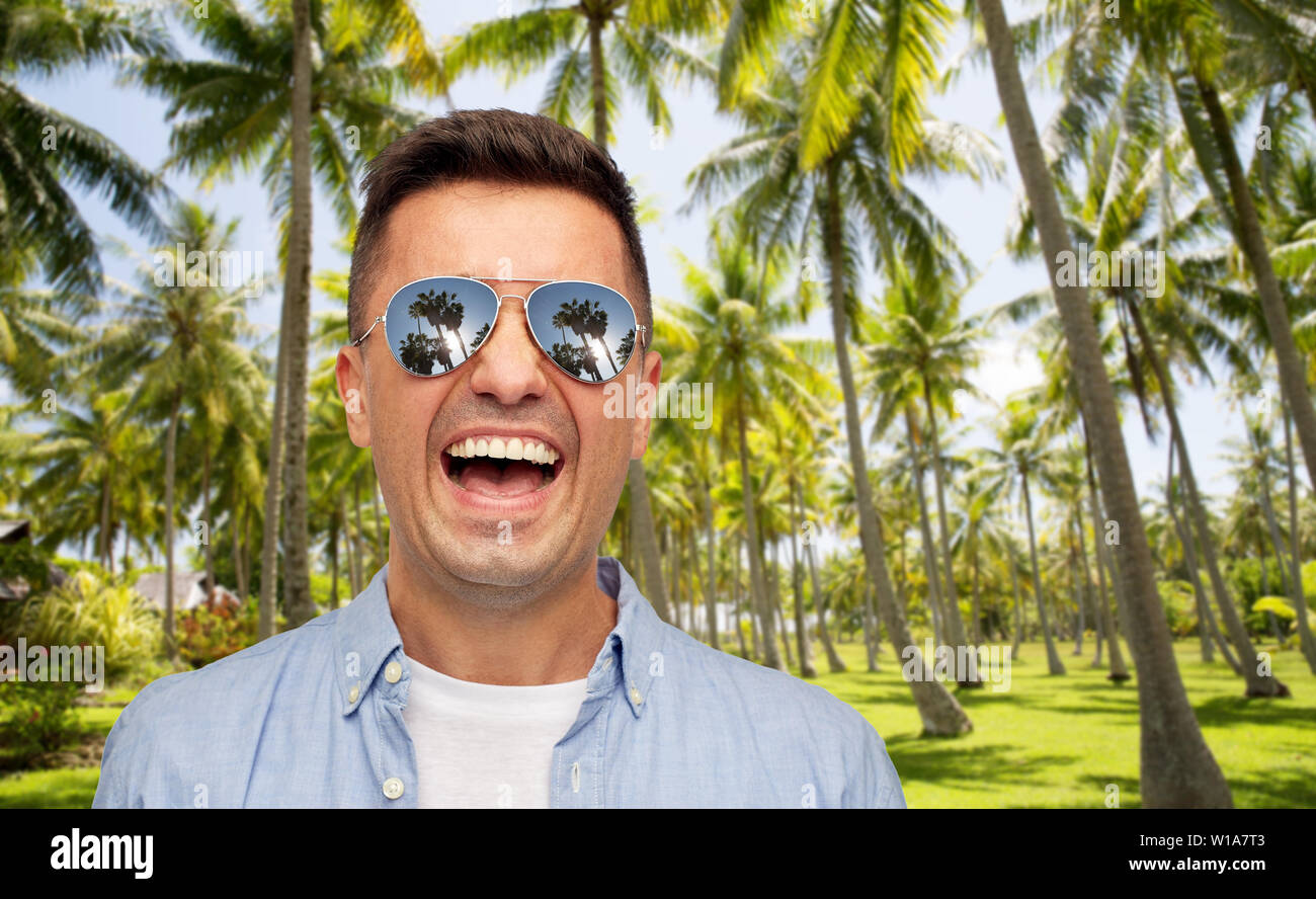 laughing man in sunglasses over tropical beach Stock Photo - Alamy