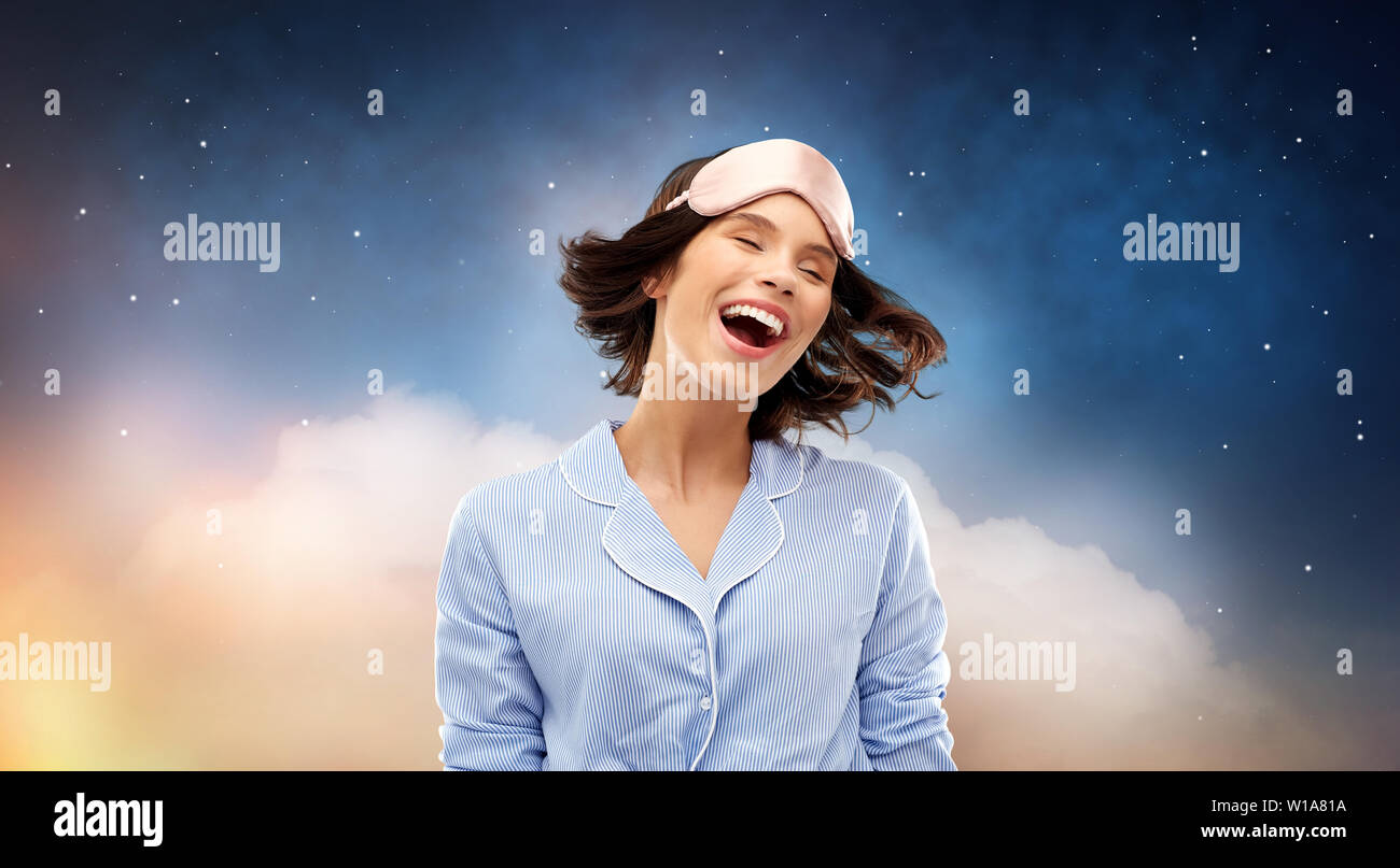 happy young woman in pajama and eye sleeping mask Stock Photo