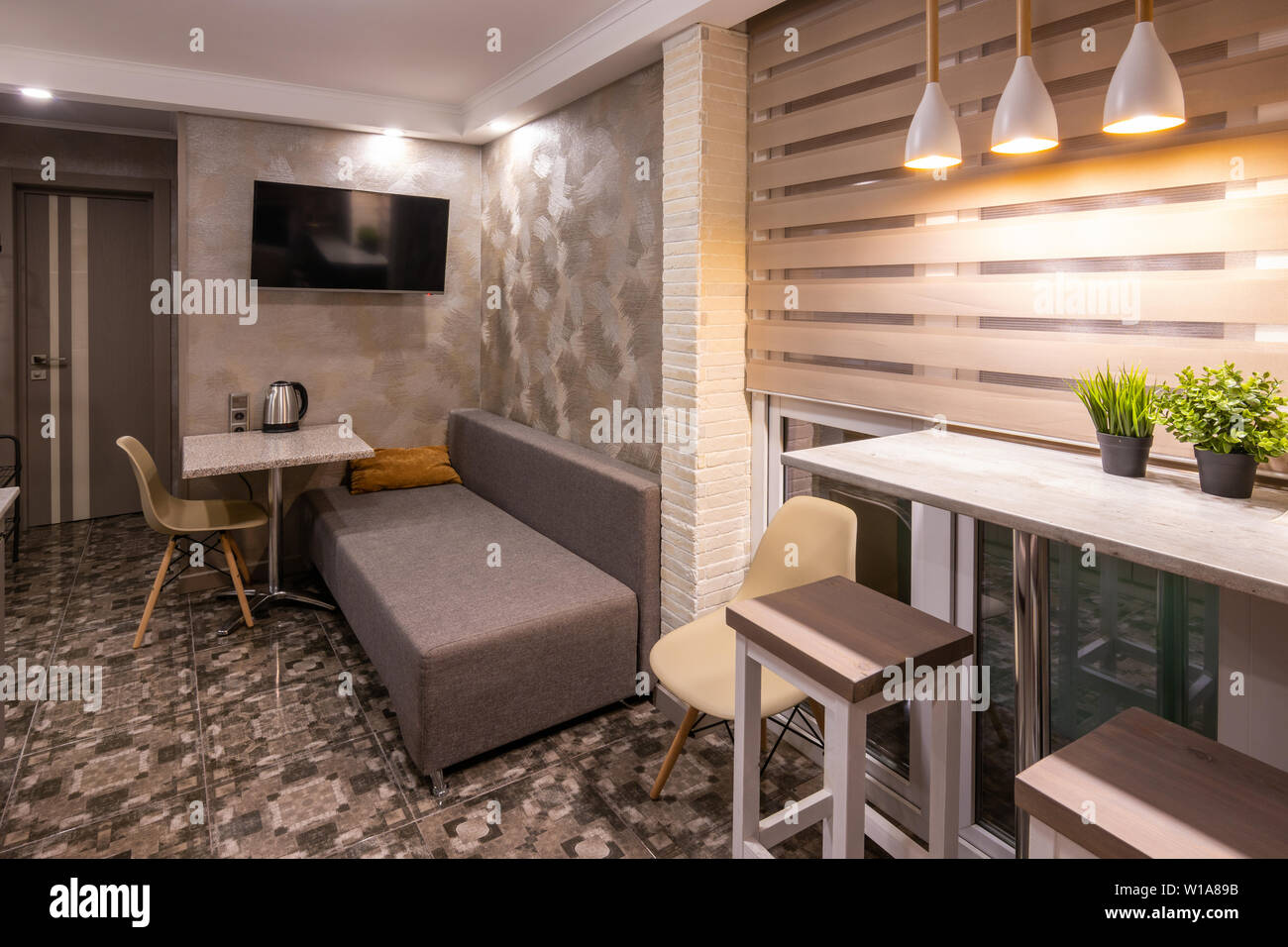 The interior of a small living room in the hotel room, combined with kitchen Stock Photo - Alamy