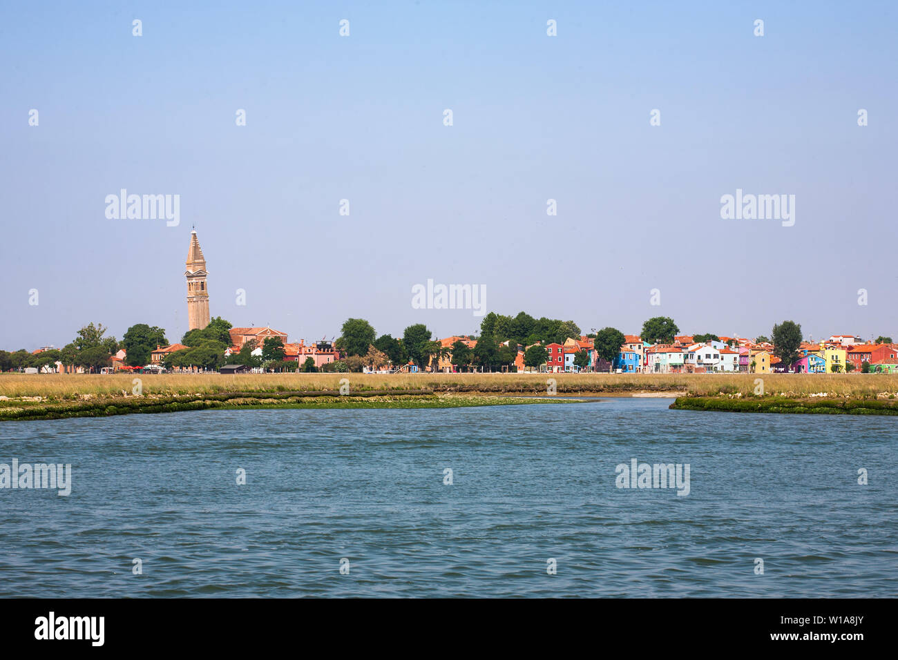 Approaching Burano, with its famous leaning tower, from the Canale di Burano, Laguna di Venezia, Veneto, Italy Stock Photo