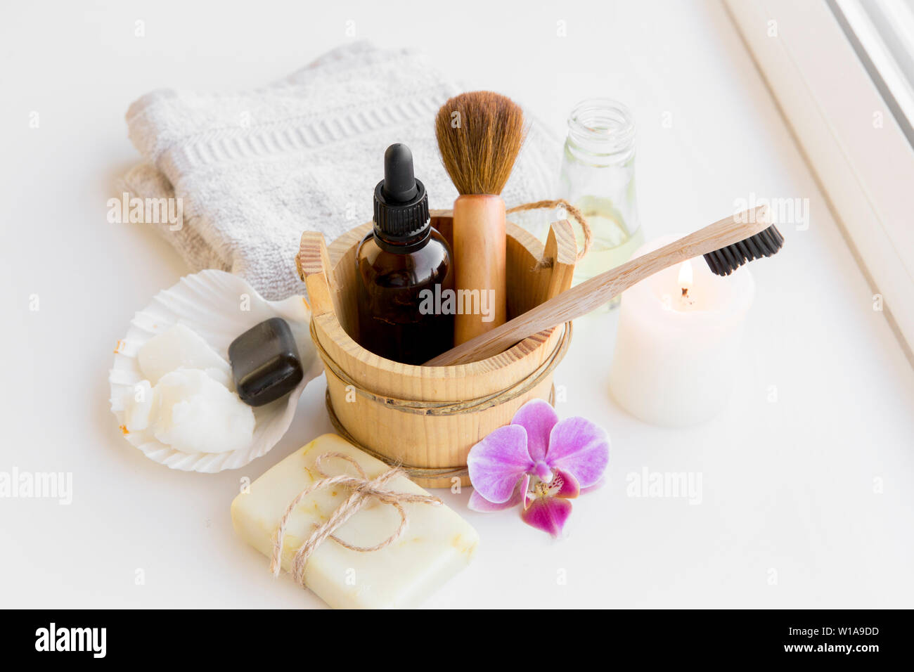 Using natural material products in home, different cosmetic products in bathroom. Minimizing ecological footprint concept. Bamboo bath towel, biodegra Stock Photo
