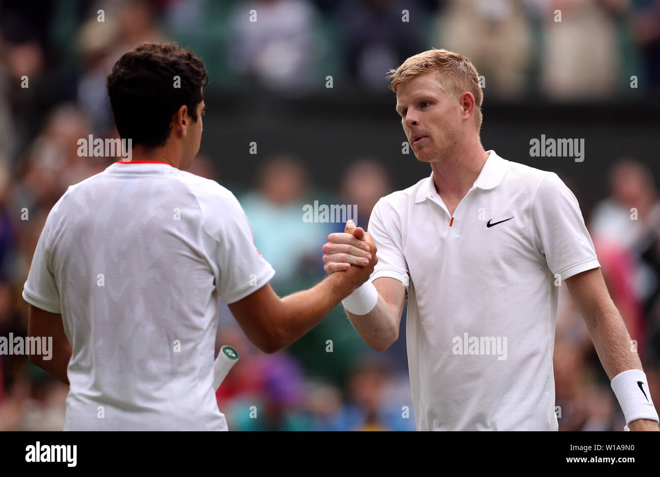 Kyle Edmund (right) and Jaume Munar shake hands after their match on day one of the Wimbledon Championships at the All England Lawn Tennis and Croquet Club, Wimbledon. Stock Photo