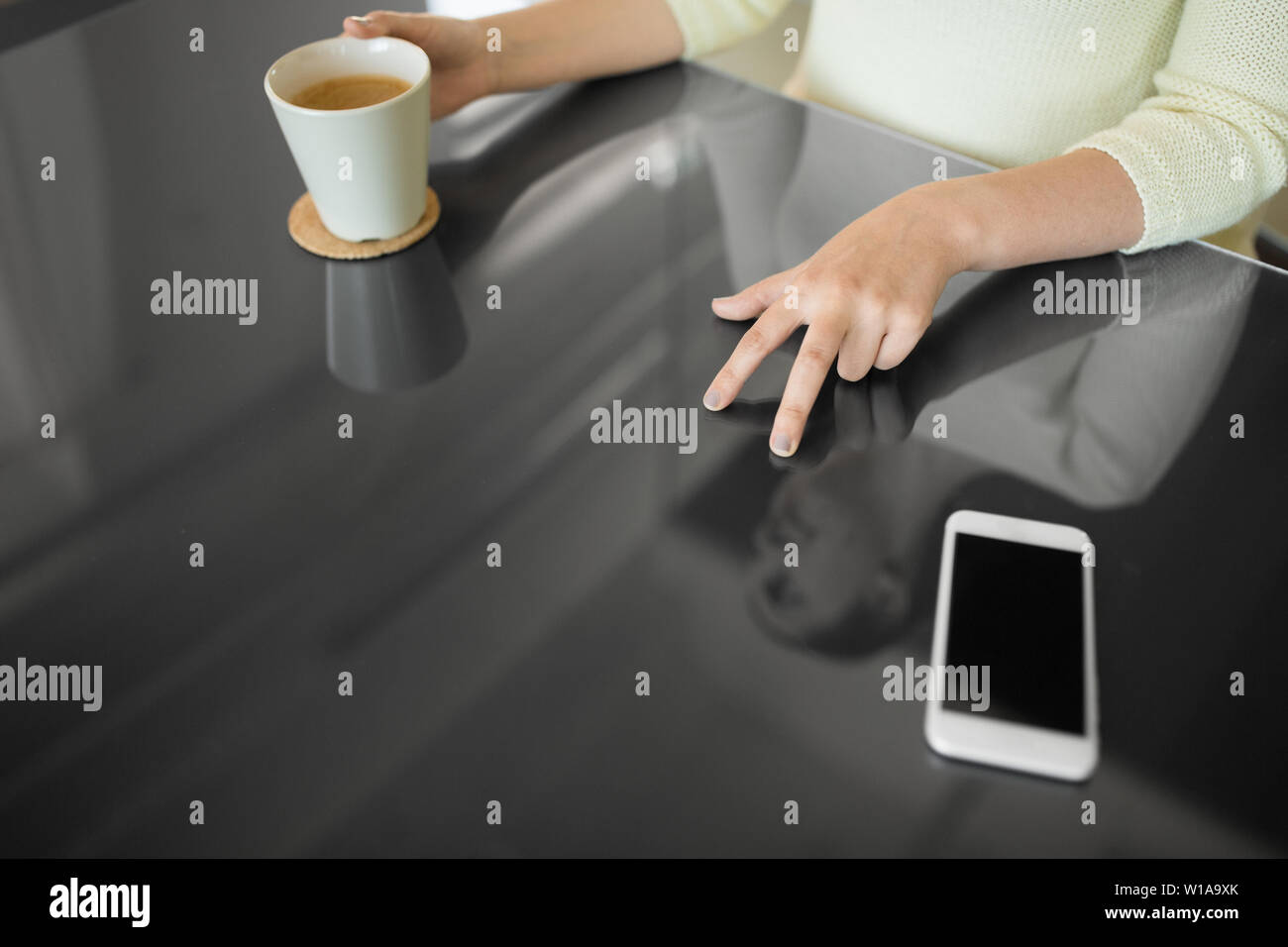 woman with coffee using black interactive panel Stock Photo