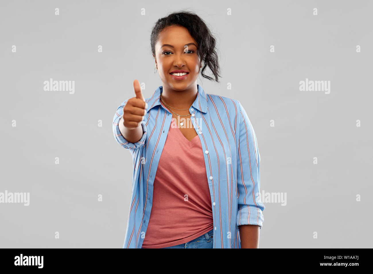 happy african american woman showing thumbs up Stock Photo - Alamy