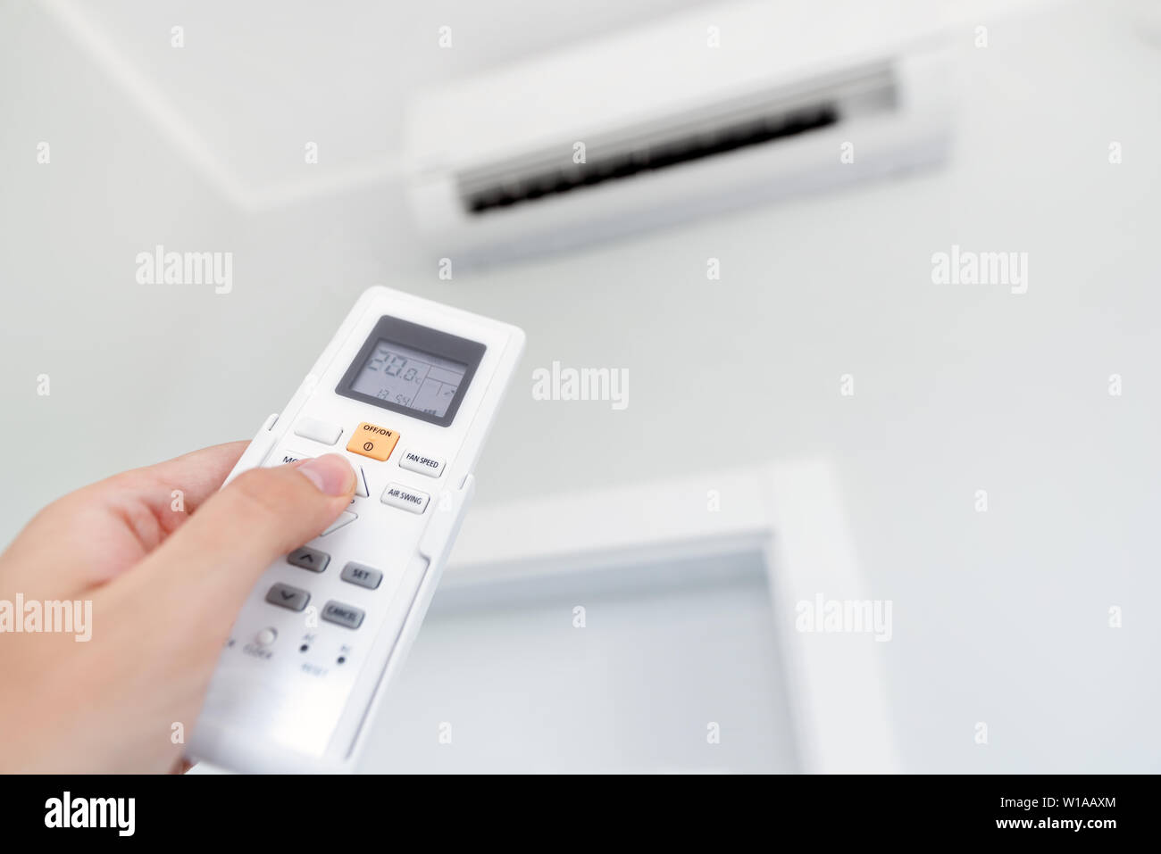 Adjusting temperature of air conditioner by remote. Air conditioning