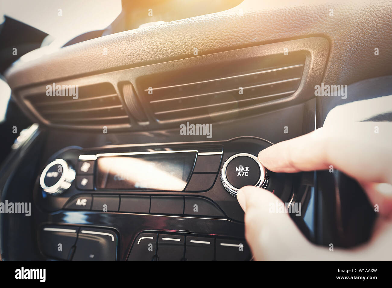 Man turning on car air conditioning system. The cooling system in the