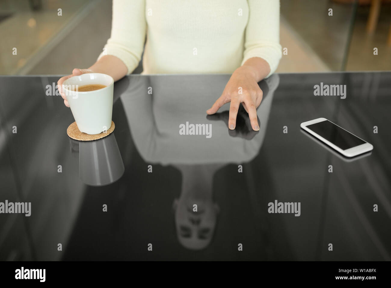 woman with coffee using black interactive panel Stock Photo