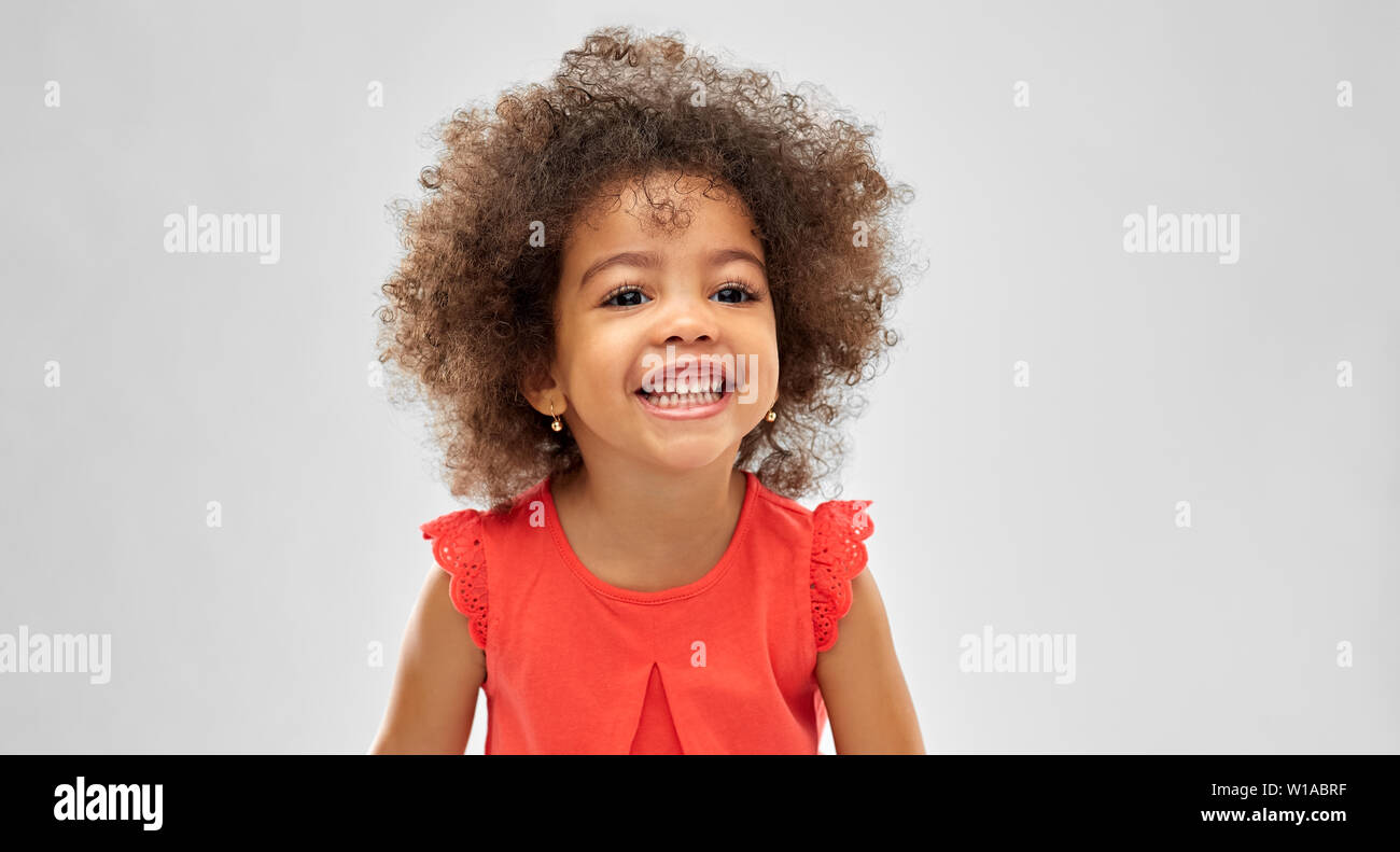 happy little african american girl over grey Stock Photo - Alamy