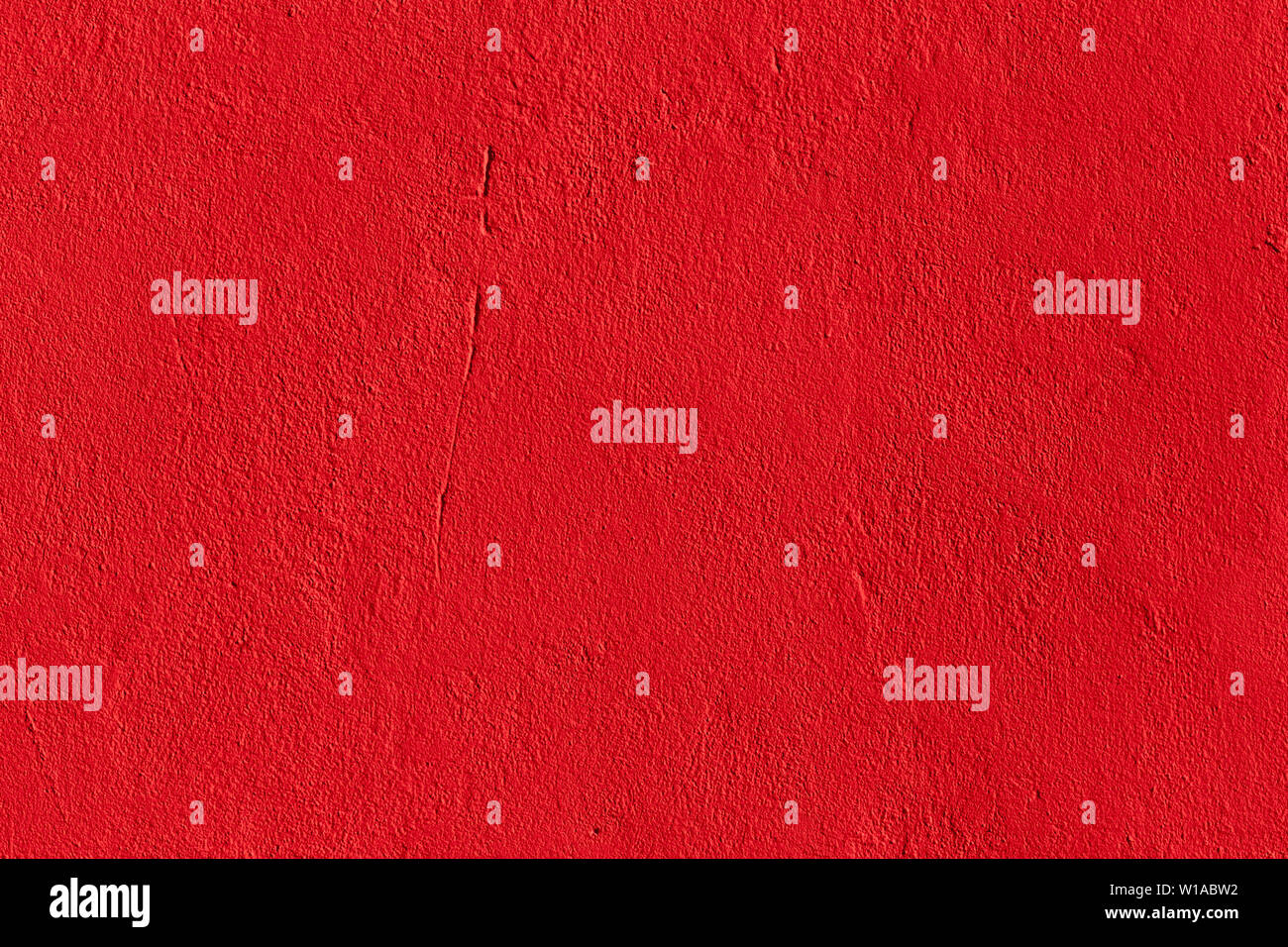 flat deep red chili pepper color plaster wall matte texture. Stock Photo